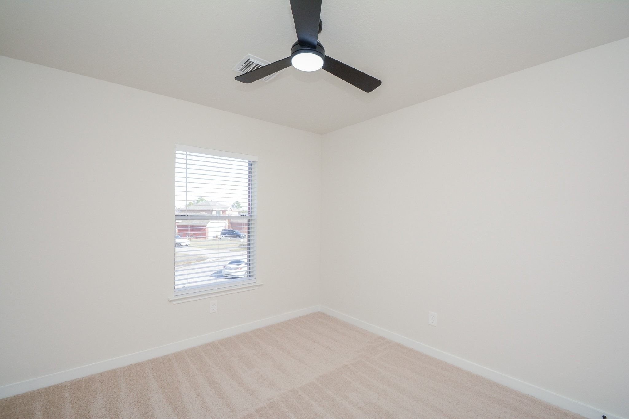 4903 South Lazy Ridge Drive Houston, TX 77053 - Photo 23 of 29 an empty room with windows and fan