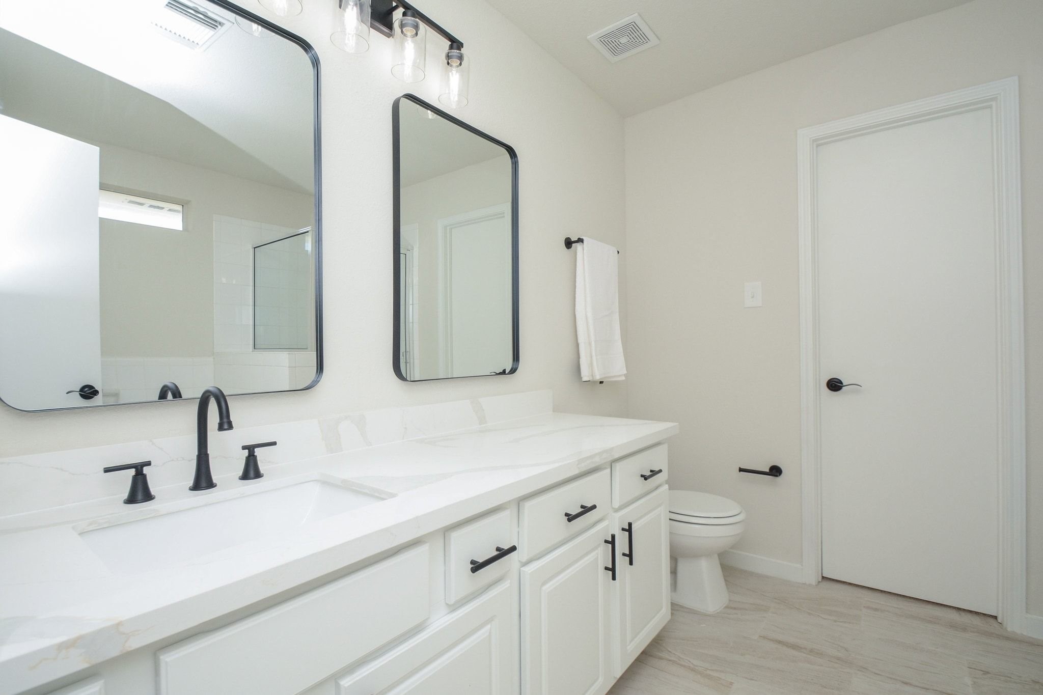 4903 South Lazy Ridge Drive Houston, TX 77053 - Photo 25 of 29 a bathroom with a double vanity sink toilet and mirror