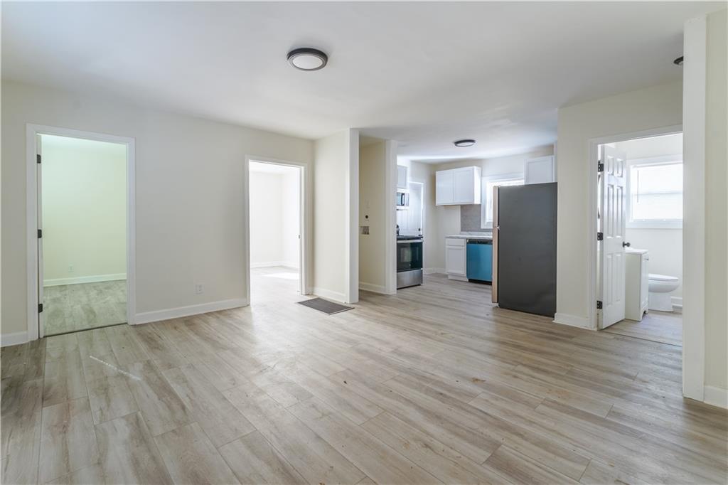 1365 Campbellton Road Southwest Atlanta, GA 30310 - Photo 5 of 36 an empty room with wooden floor and a window