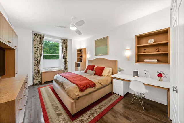 a kitchen with stainless steel appliances wooden floor and stove top oven