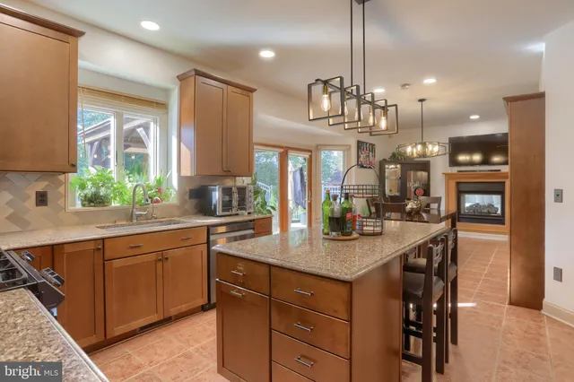 a kitchen with stainless steel appliances granite countertop a sink a stove and a refrigerator