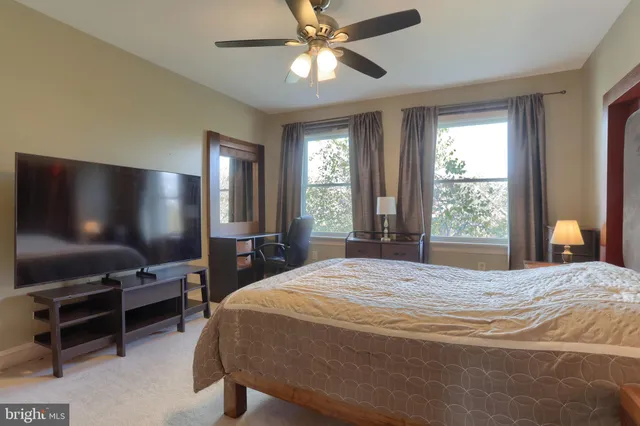 a bedroom with furniture and a mirror