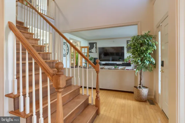 a view of entryway with wooden floor and stairs