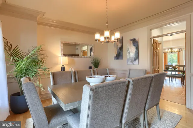 a view of a dining room with furniture and chandelier