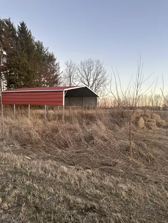 a view of a small yard with wooden fence