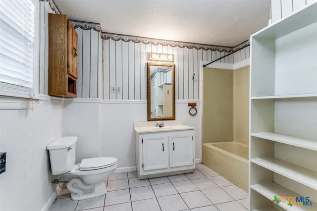 a bathroom with a toilet a sink and bathtub