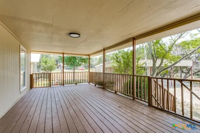 a view of balcony with wooden floor