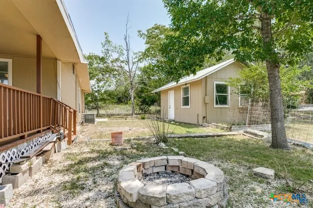 a backyard of a house with yard and outdoor seating