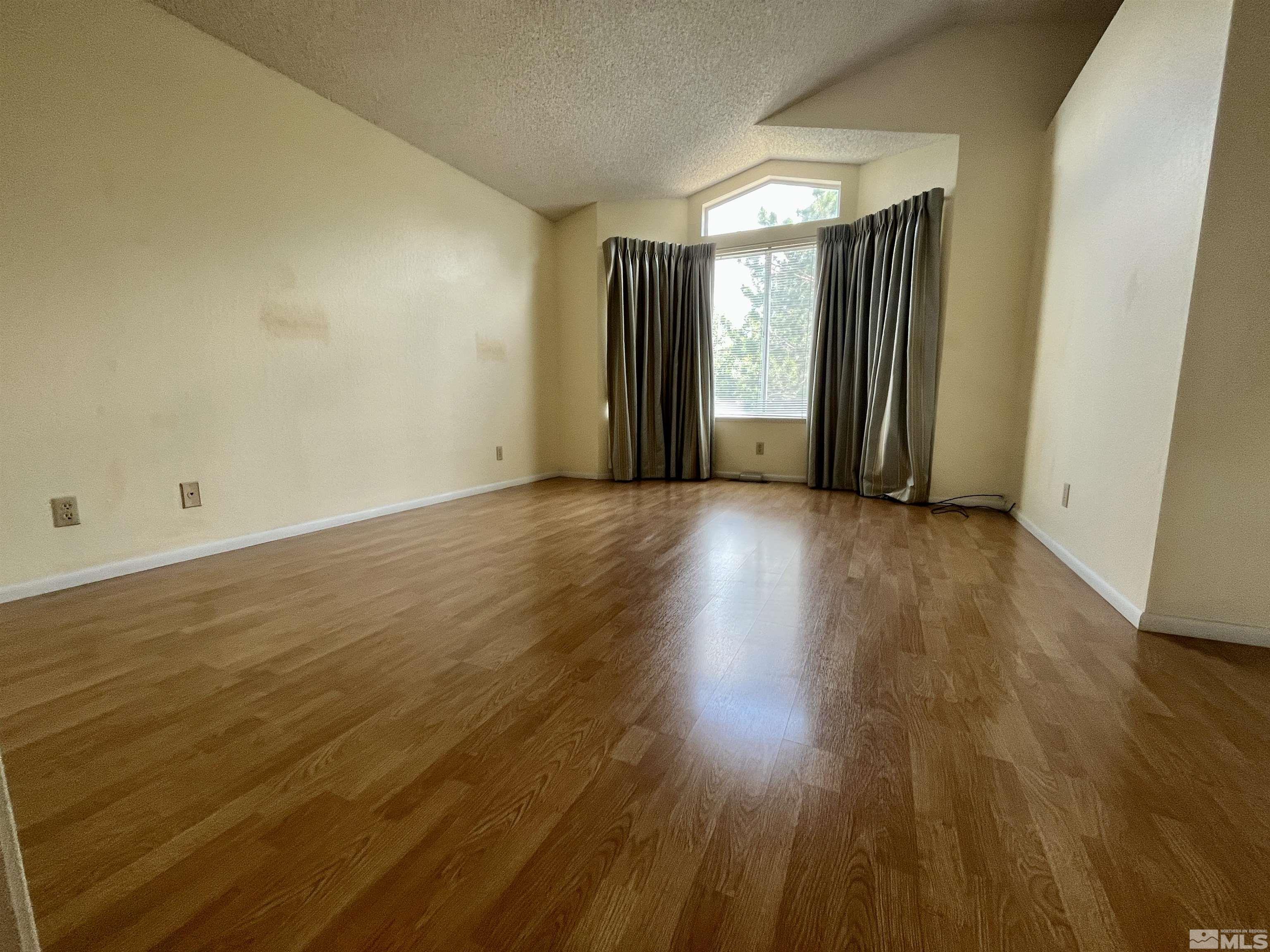6310 Park Place Reno, NV 89523 - Photo 11 of 22 an empty room with wooden floor and windows