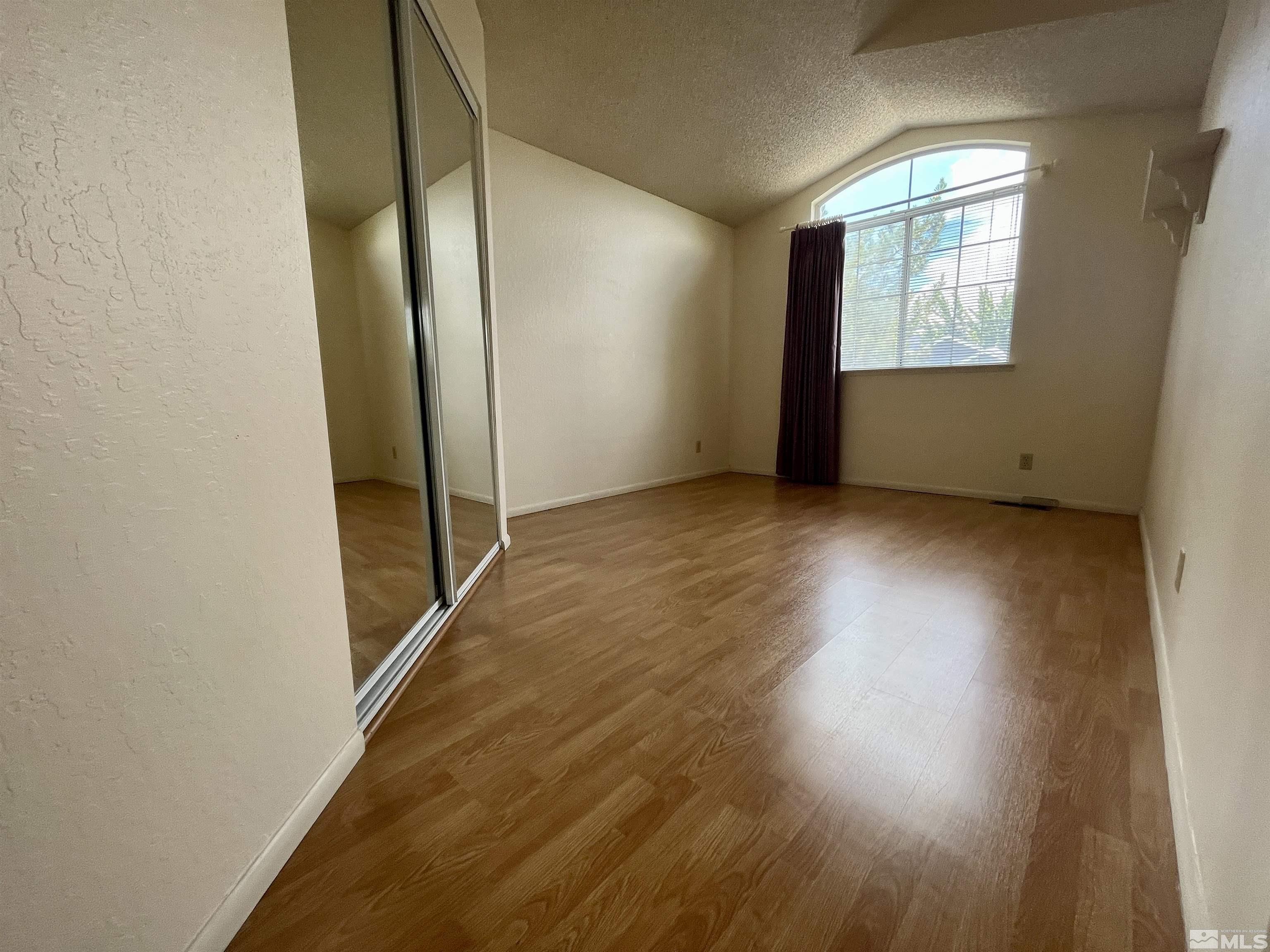 6310 Park Place Reno, NV 89523 - Photo 15 of 22 an empty room with wooden floor and windows