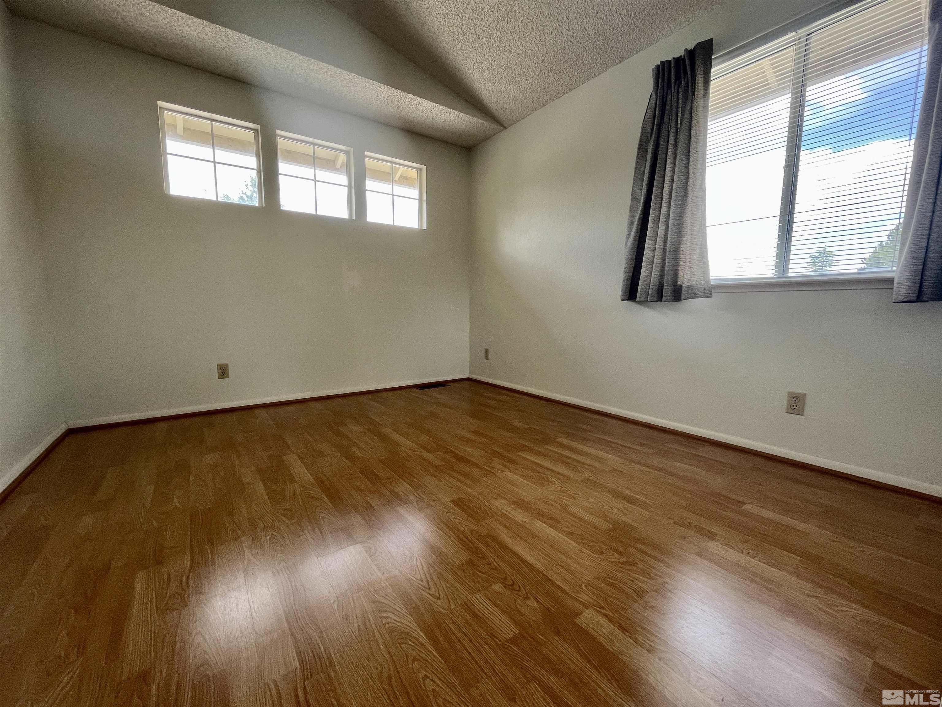 6310 Park Place Reno, NV 89523 - Photo 16 of 22 an empty room with wooden floor and windows
