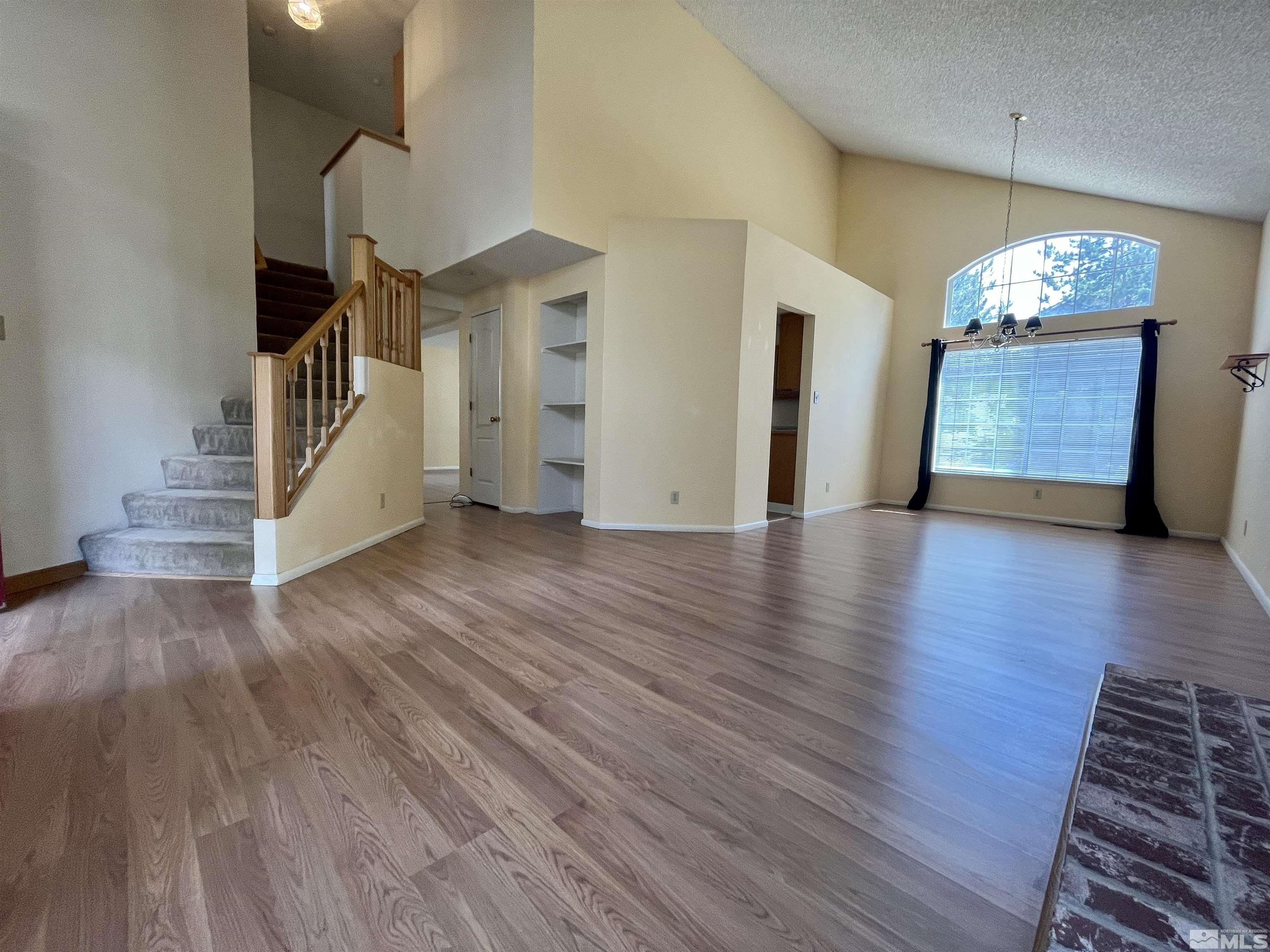 6310 Park Place Reno, NV 89523 - Photo 3 of 22 a view of an empty room with wooden floor and staircase