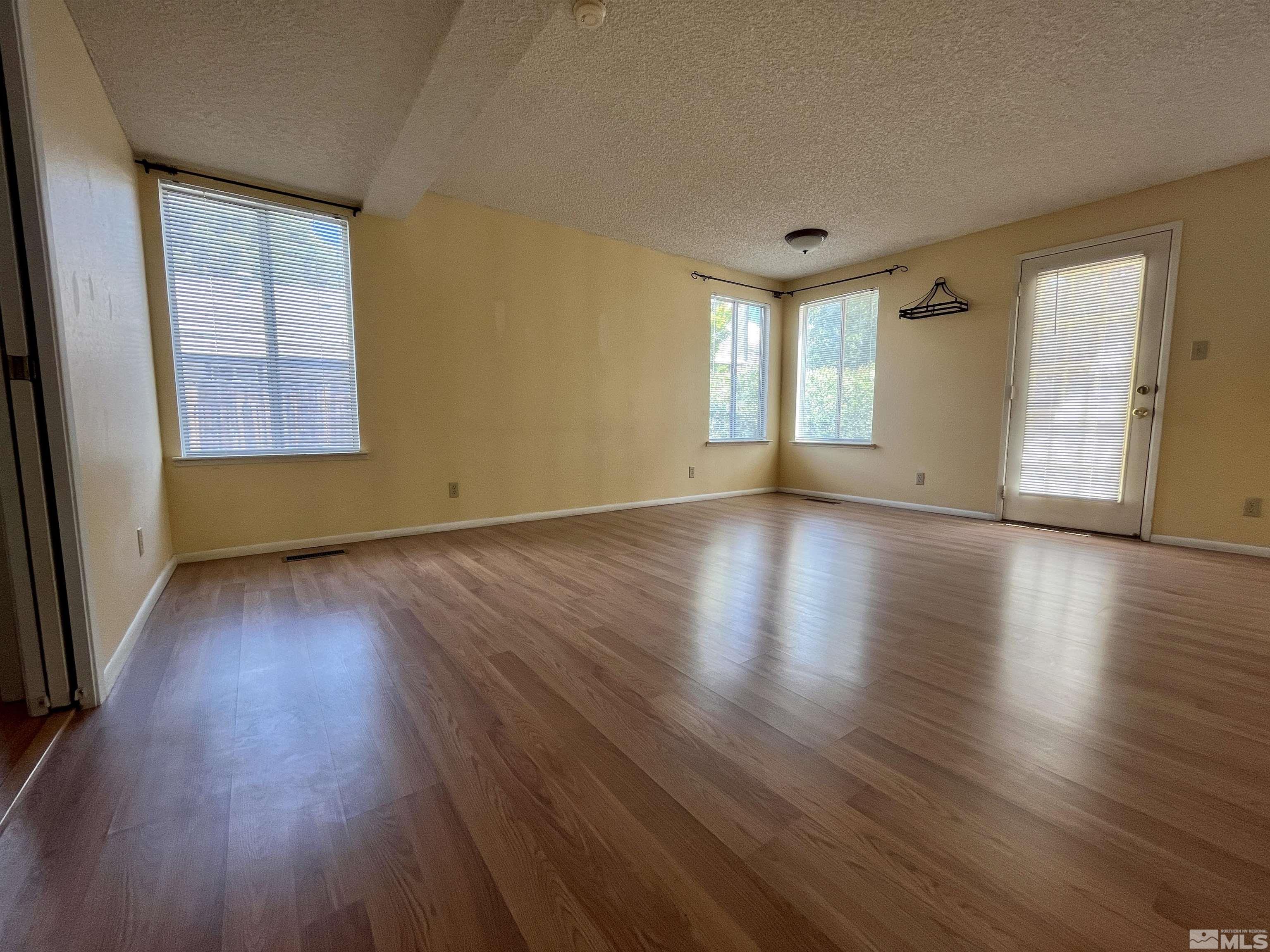 6310 Park Place Reno, NV 89523 - Photo 6 of 22 a view of an empty room with wooden floor and a window
