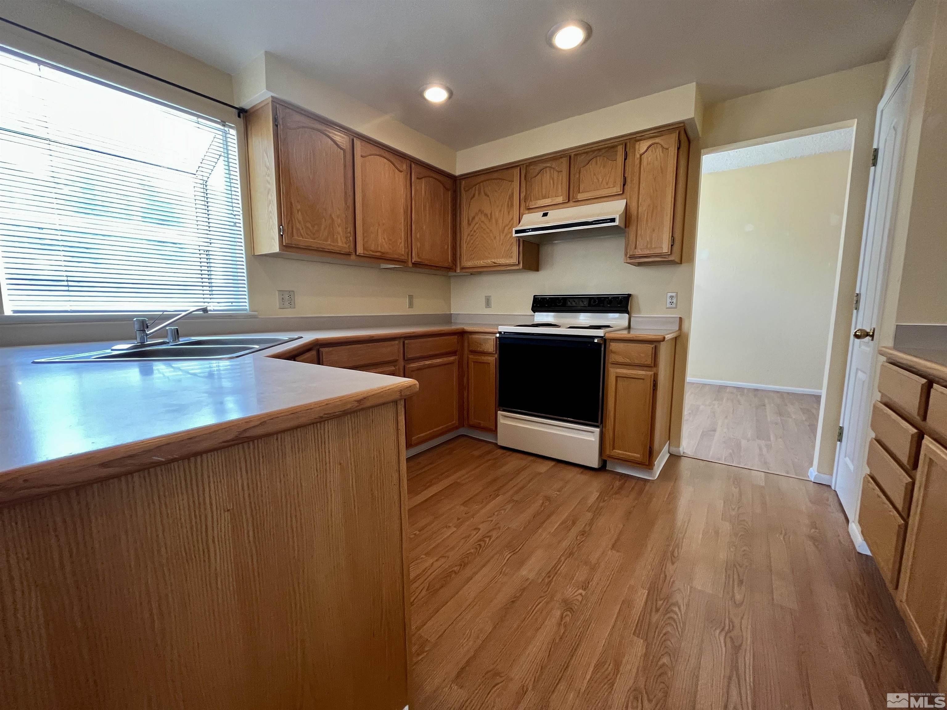 6310 Park Place Reno, NV 89523 - Photo 7 of 22 a kitchen with stainless steel appliances granite countertop a stove a sink and a refrigerator