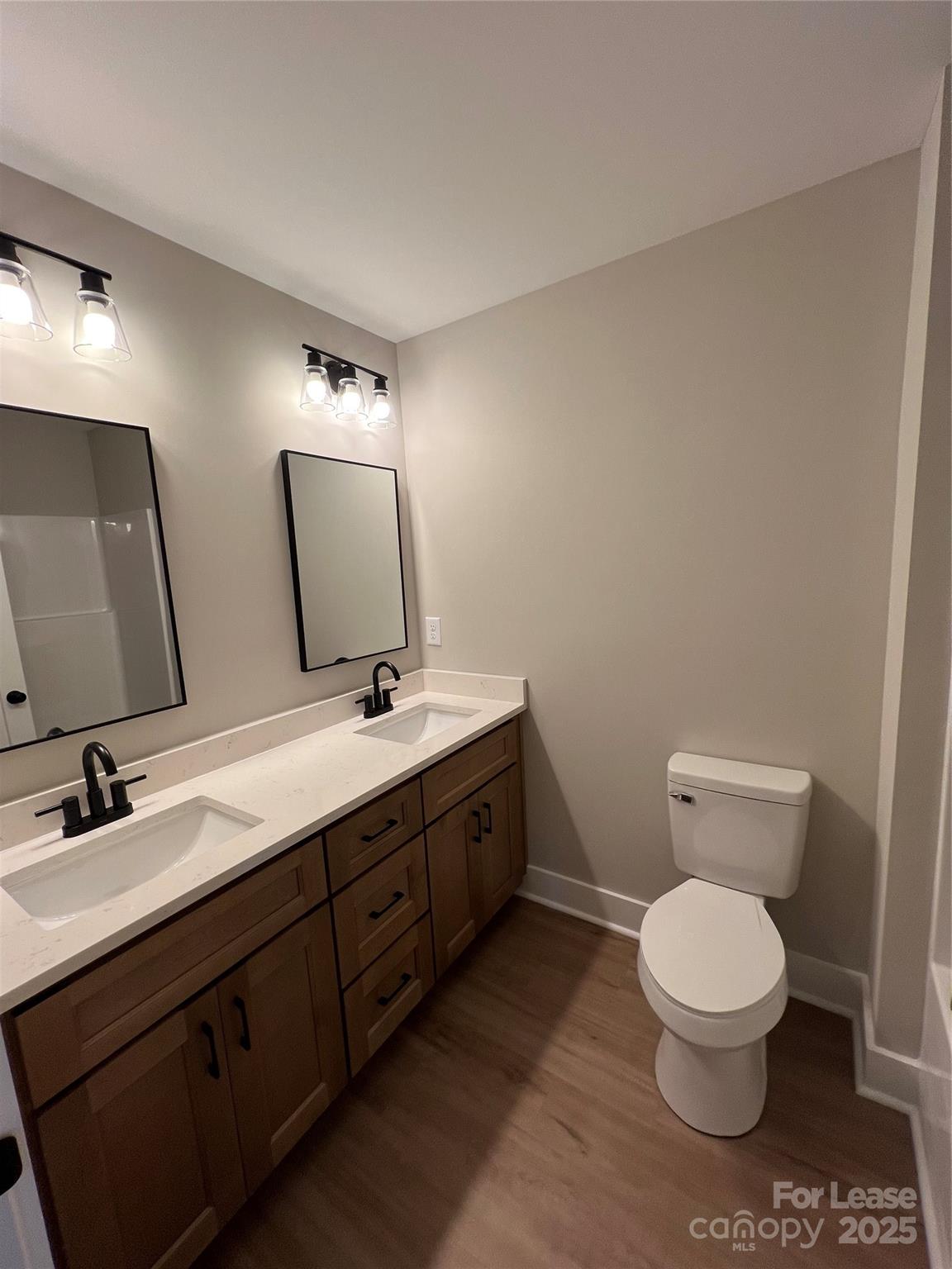 402 North 4th Street Albemarle, NC 28001 - Photo 12 of 19 a bathroom with a toilet sink and mirror