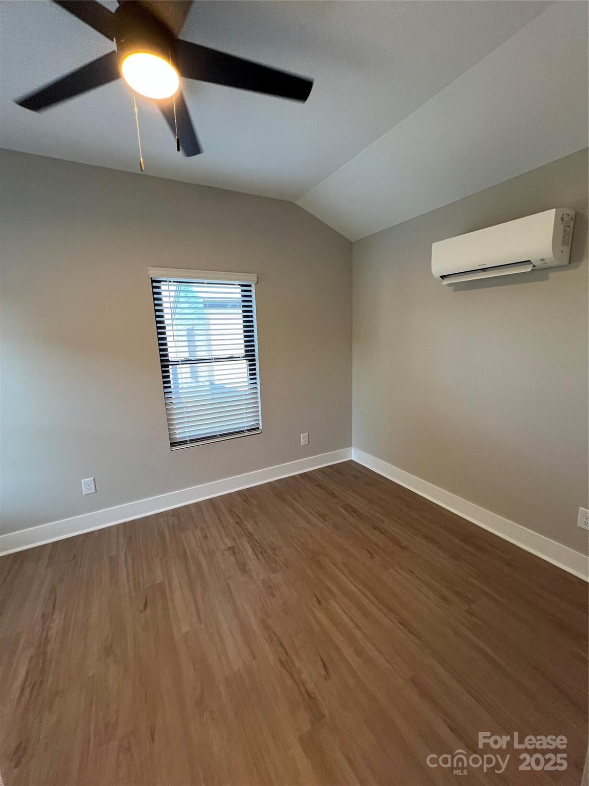 402 North 4th Street Albemarle, NC 28001 - Photo 13 of 19 an empty room with wooden floor and windows