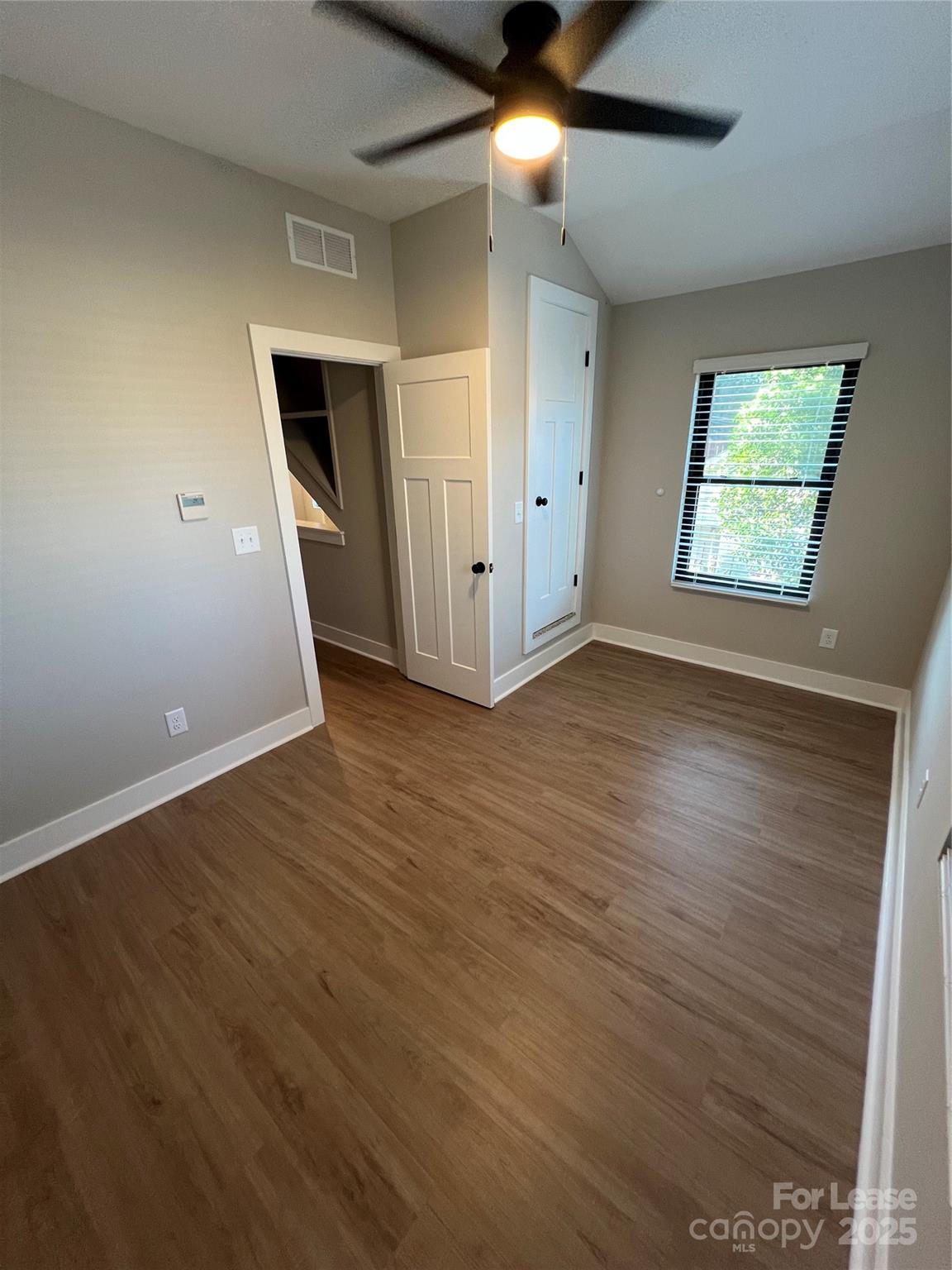 402 North 4th Street Albemarle, NC 28001 - Photo 14 of 19 an empty room with wooden floor and windows
