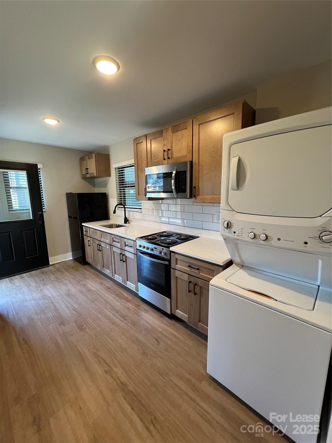 402 North 4th Street Albemarle, NC 28001 - Photo 5 of 19 a kitchen with stainless steel appliances a stove a sink and a refrigerator