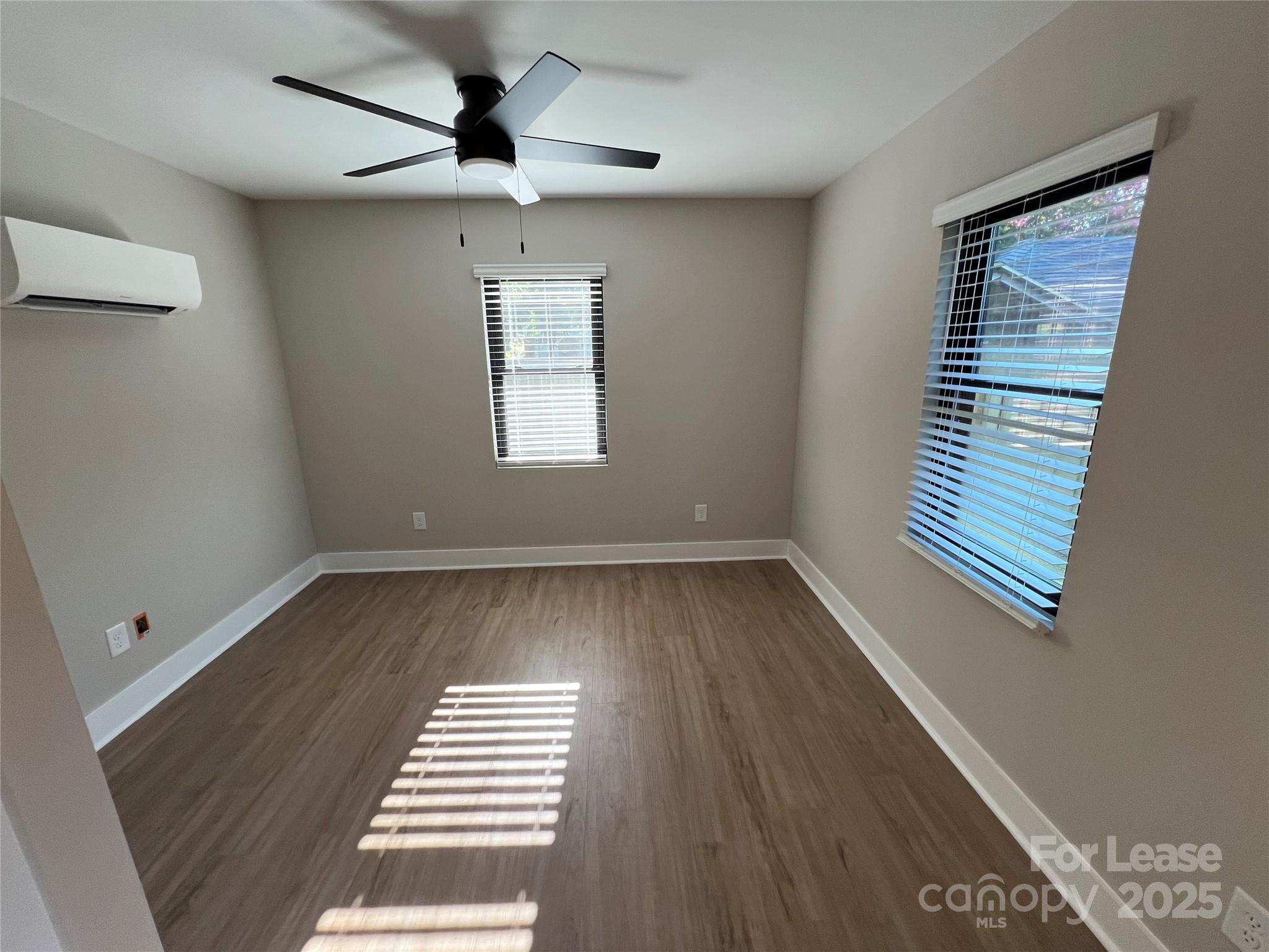 402 North 4th Street Albemarle, NC 28001 - Photo 6 of 19 an empty room with wooden floor and windows