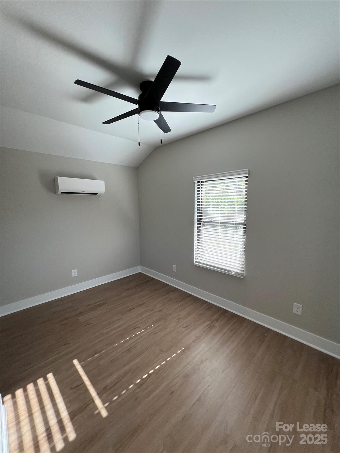 402 North 4th Street Albemarle, NC 28001 - Photo 10 of 19 an empty room with a empty space and a ceiling fan