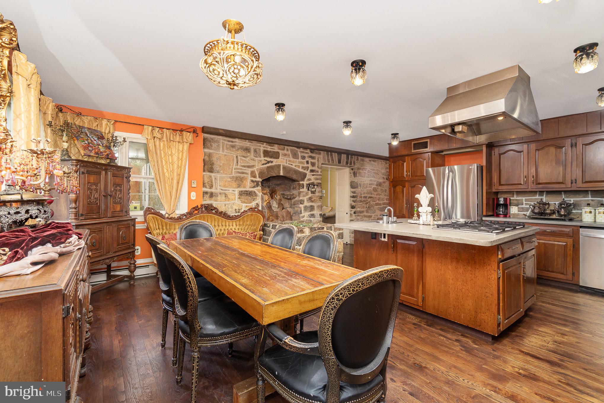 1554 Williams Grove Road Dillsburg, PA 17019 - Photo 18 of 75 a dining room with stainless steel appliances granite countertop a kitchen island a stove a table and chairs