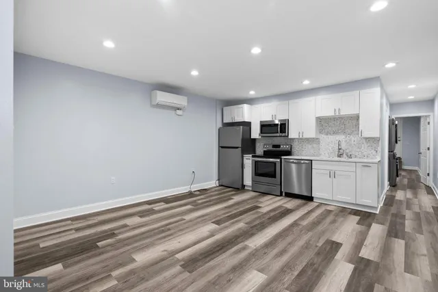 a kitchen with stainless steel appliances granite countertop a refrigerator sink and cabinets