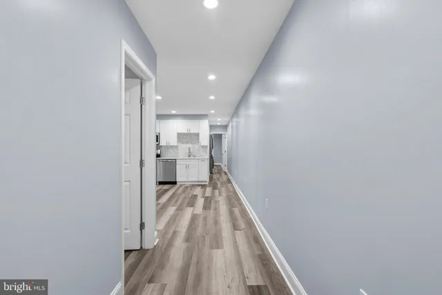 a view of a hallway with wooden floor