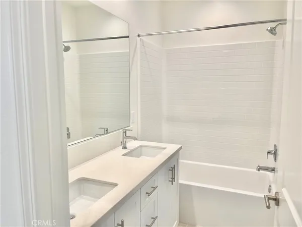 a bathroom with a shower and a sink