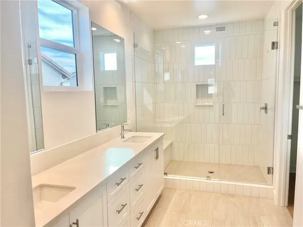 a bathroom with a tub sink and mirror