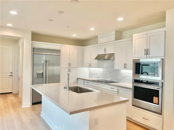 a kitchen with a stove a sink and a refrigerator