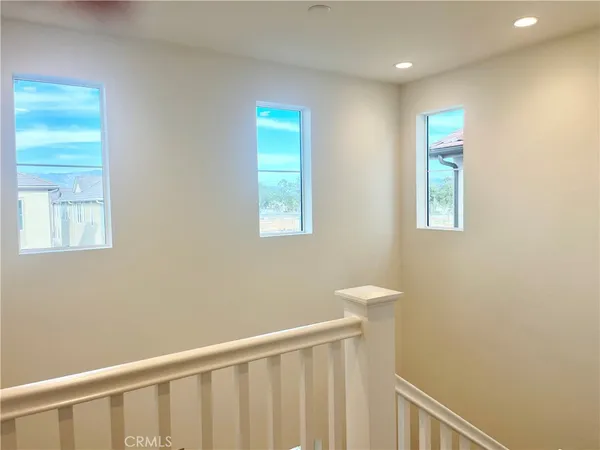 a view of a hallway with windows