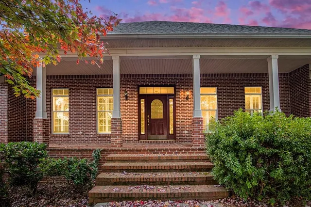 a front view of a house with a garden