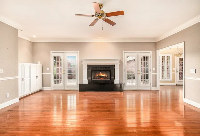a view of an empty room with glass door and a window