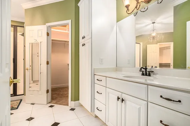 a spacious bathroom with a shower sink and mirror