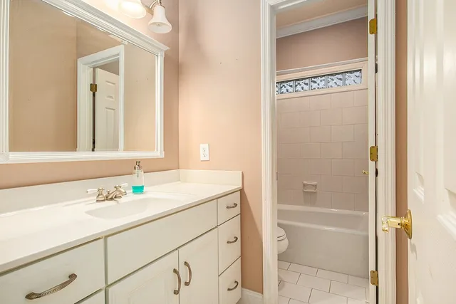 a bathroom with a granite countertop sink a mirror and a