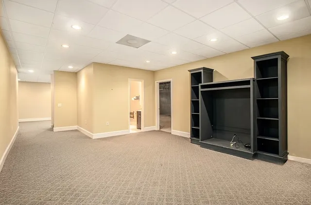 a view of an empty room with furniture and entryway