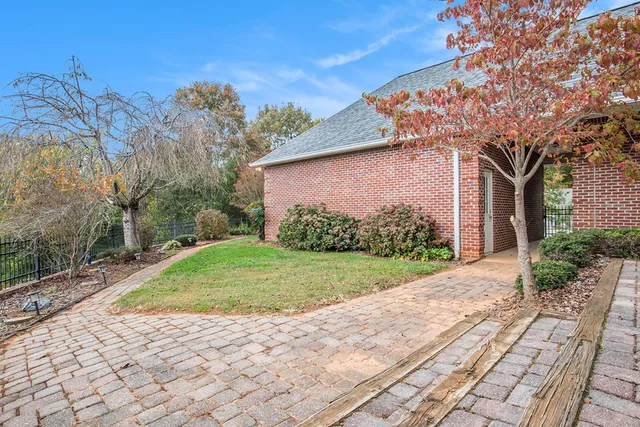 a pathway of a house with a yard