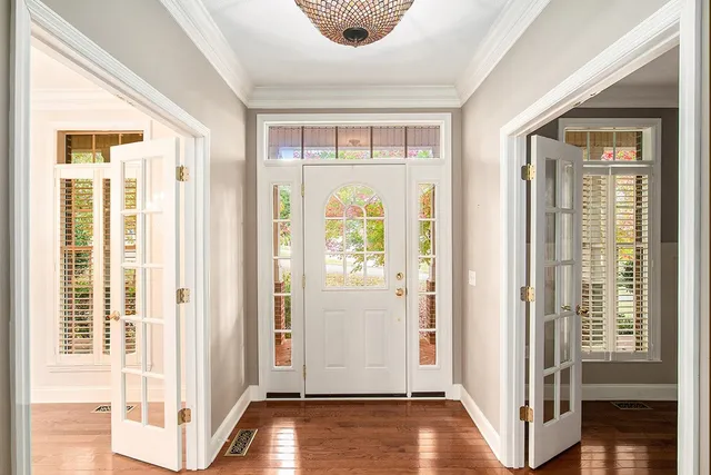 a view of a livingroom with wooden floor and windows