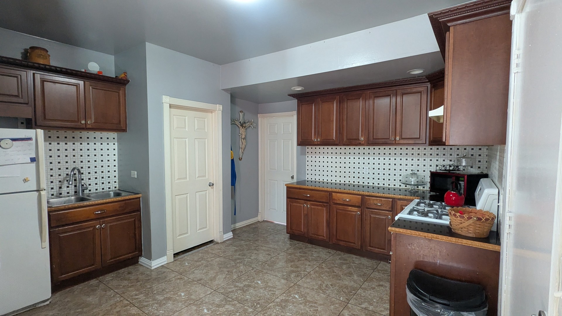 23 North Jackson Street Waukegan, IL 60085 - Photo 10 of 26 a kitchen with stainless steel appliances granite countertop a refrigerator and a stove top oven