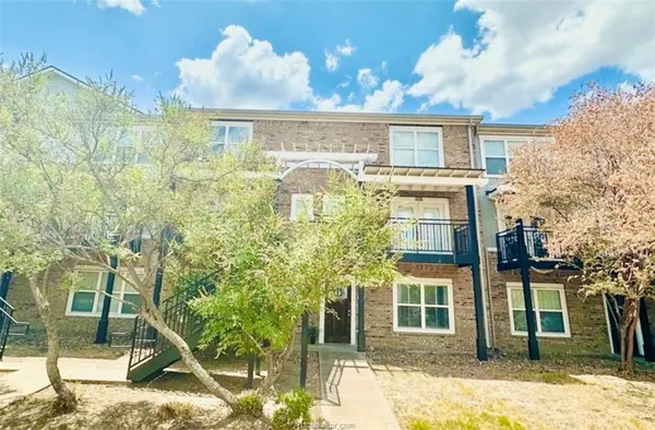a view of a residential apartment building with a yard