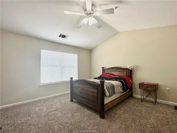 a room with a bed and window