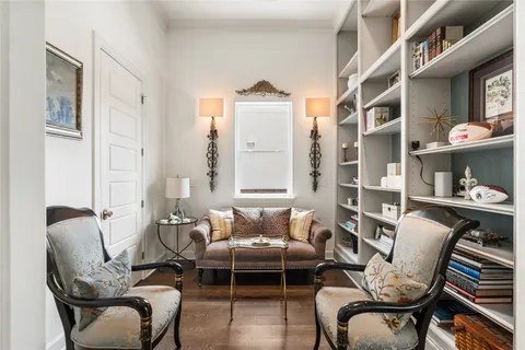 a living room with furniture fireplace and a window