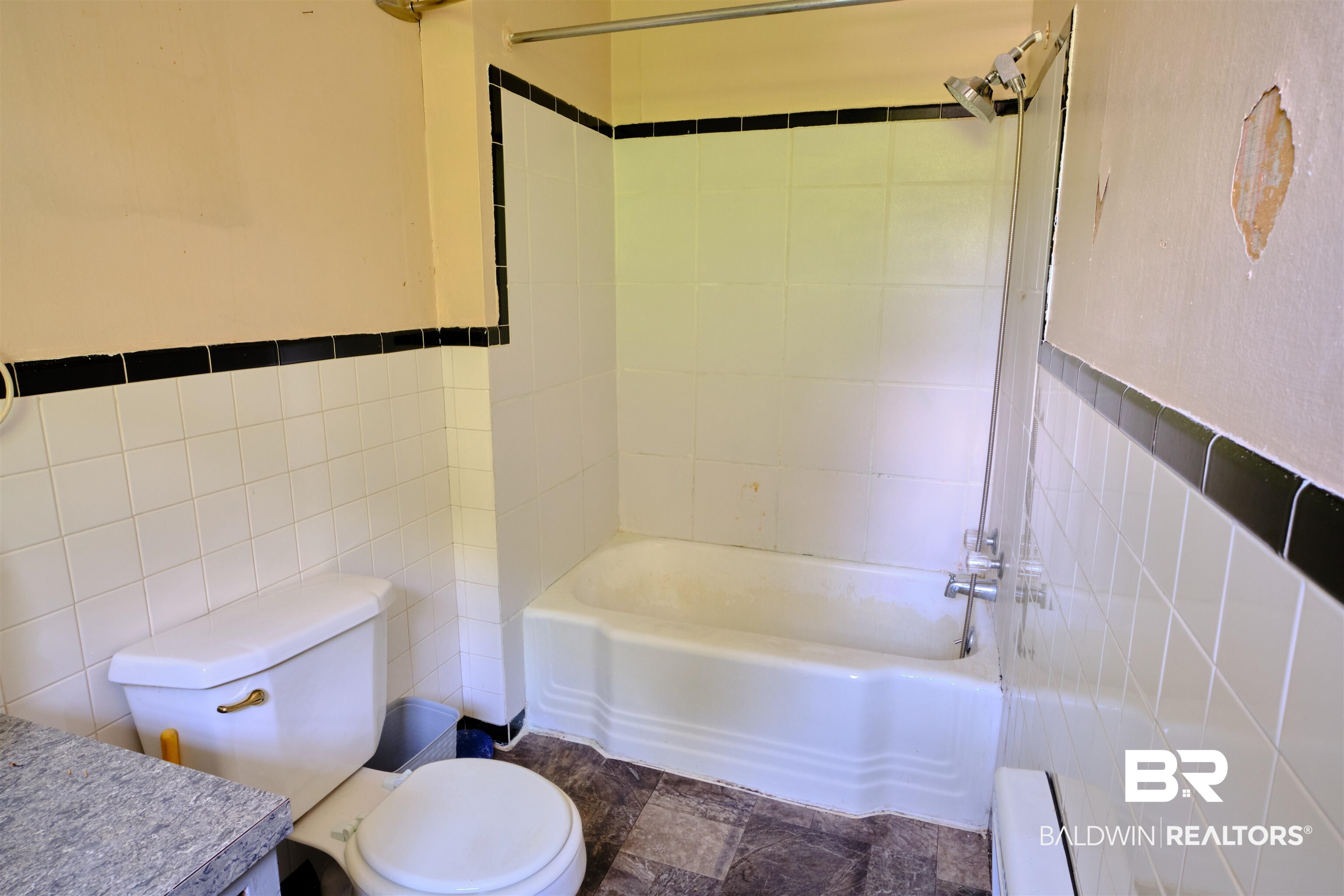 101 West Horner Street Atmore, AL 36502 - Photo 4 of 38 Full bathroom featuring toilet, tiled shower / bath, tile patterned flooring, and tile walls