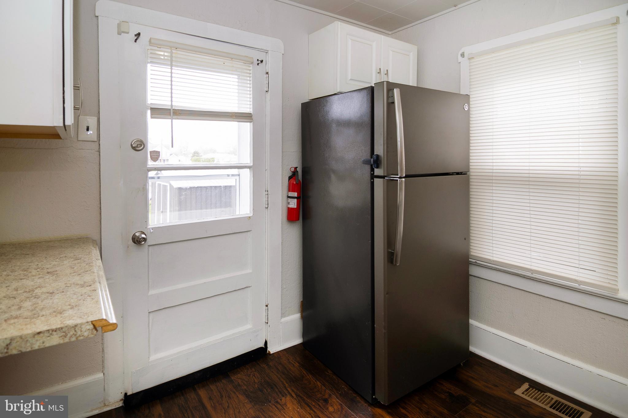 211 Chestnut Street Glendora, NJ 08029 - Photo 11 of 34 a view of kitchen with wooden floor refrigerator and window
