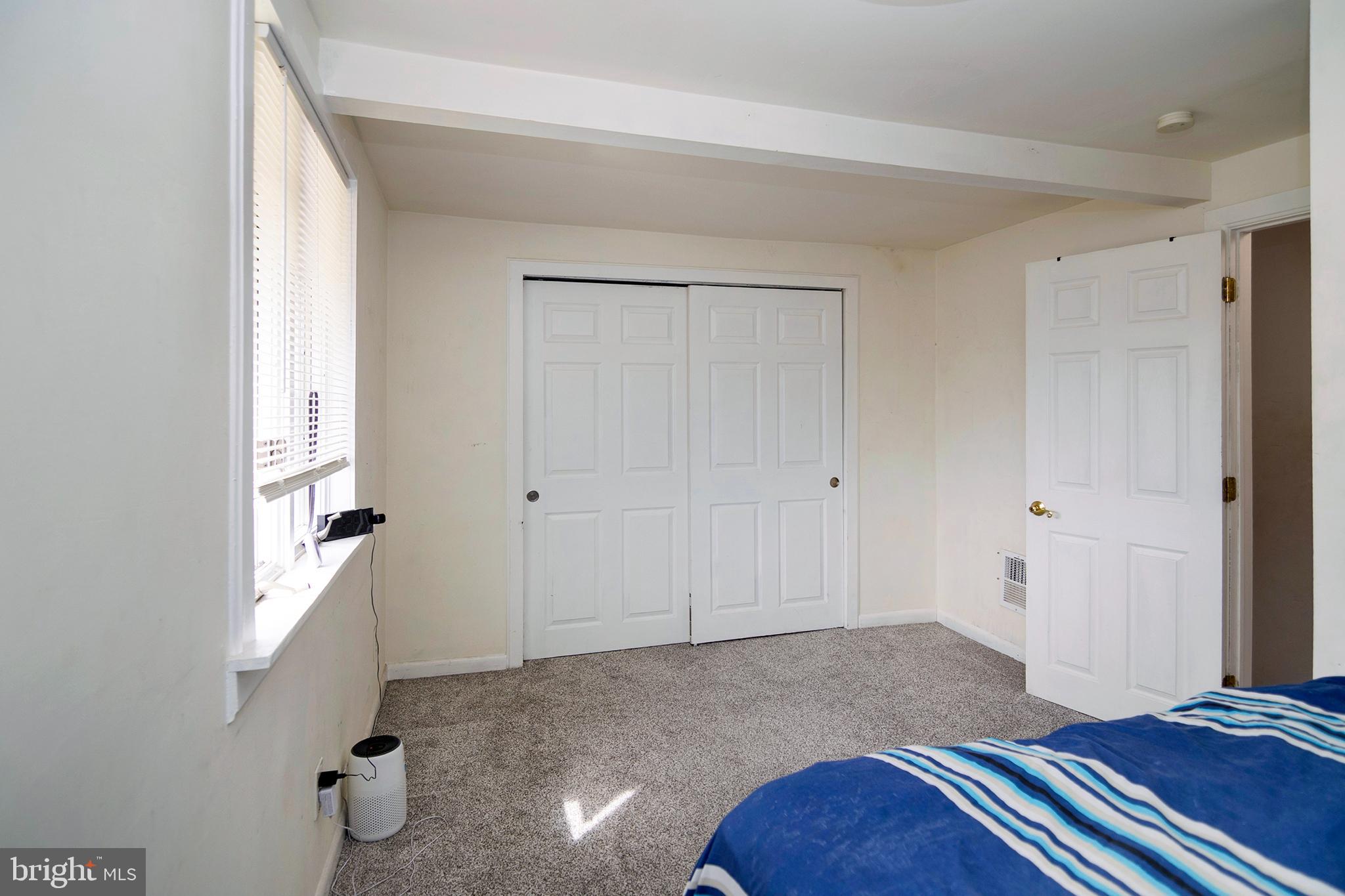 211 Chestnut Street Glendora, NJ 08029 - Photo 16 of 34 a bedroom with a bed and a hallway