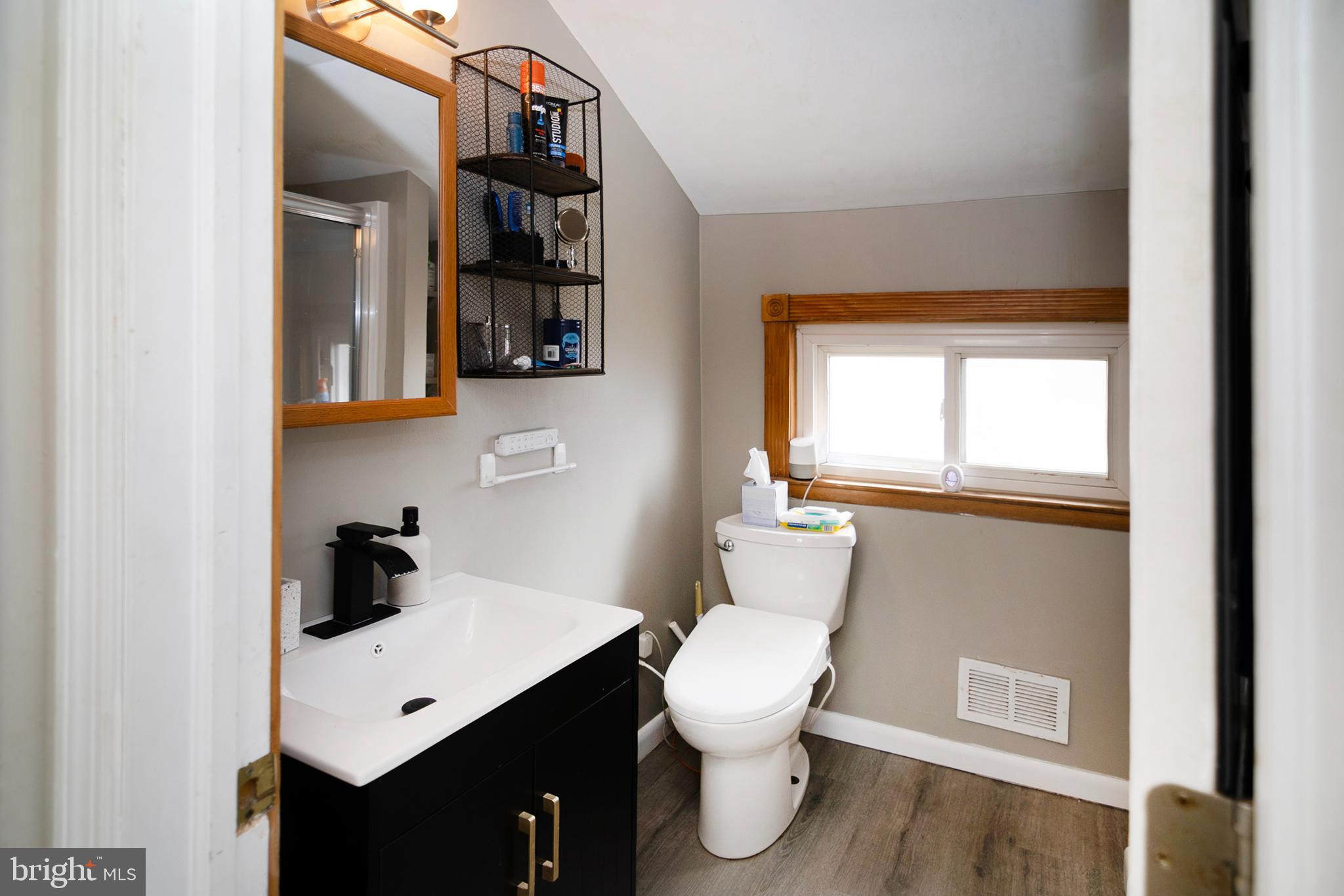 211 Chestnut Street Glendora, NJ 08029 - Photo 18 of 34 a bathroom with a toilet sink and mirror