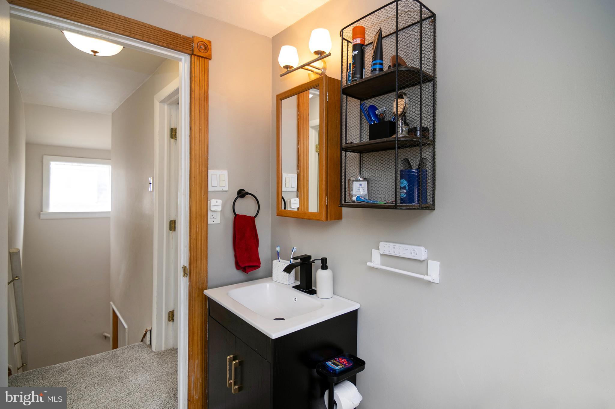 211 Chestnut Street Glendora, NJ 08029 - Photo 19 of 34 a bathroom with a sink vanity and mirror