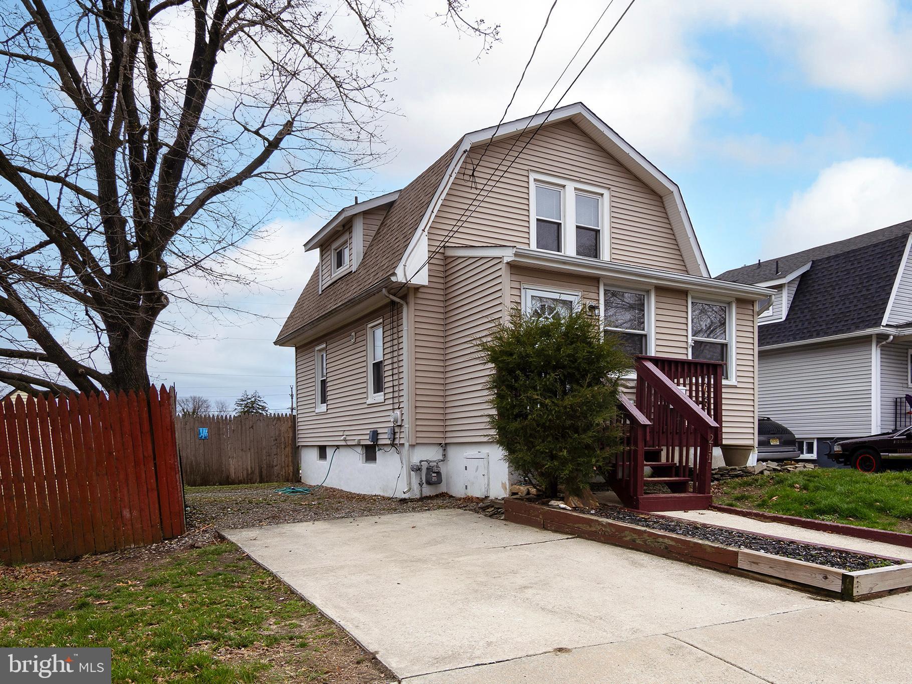 211 Chestnut Street Glendora, NJ 08029 - Photo 2 of 34 a front view of a house with garden