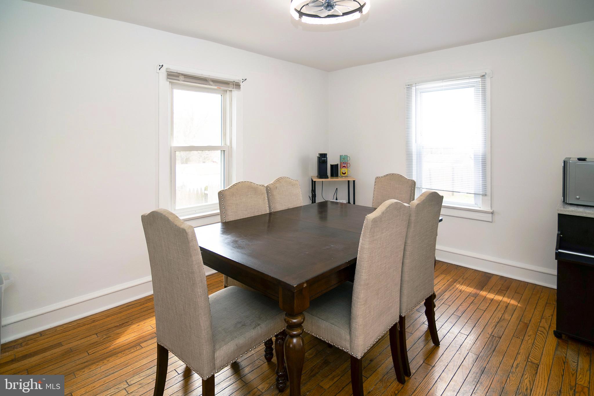211 Chestnut Street Glendora, NJ 08029 - Photo 7 of 34 a view of a dining room with furniture and wooden floor