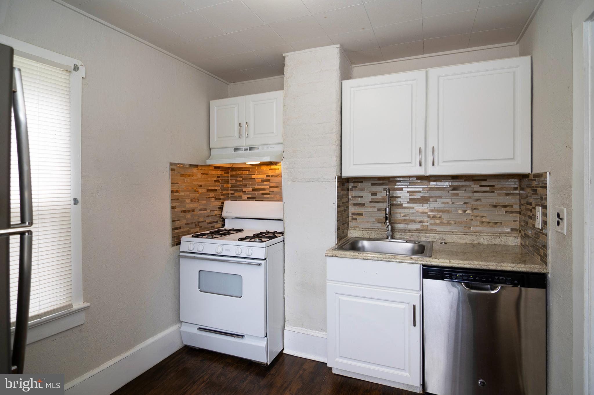 211 Chestnut Street Glendora, NJ 08029 - Photo 9 of 34 a kitchen with white cabinets and white appliances